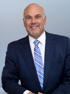 Jay Cohen Florida Attorney - leaning, blue background - image