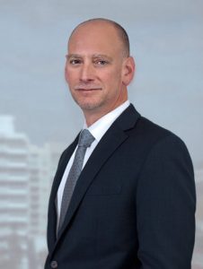 image of Jeff Blostein Florida Attorney - standing in front of window
