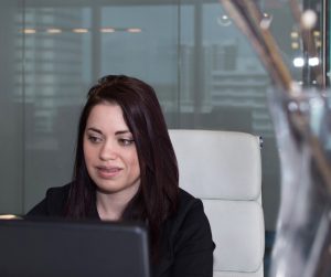 photo of Receptionist sitting at her desk, smiling